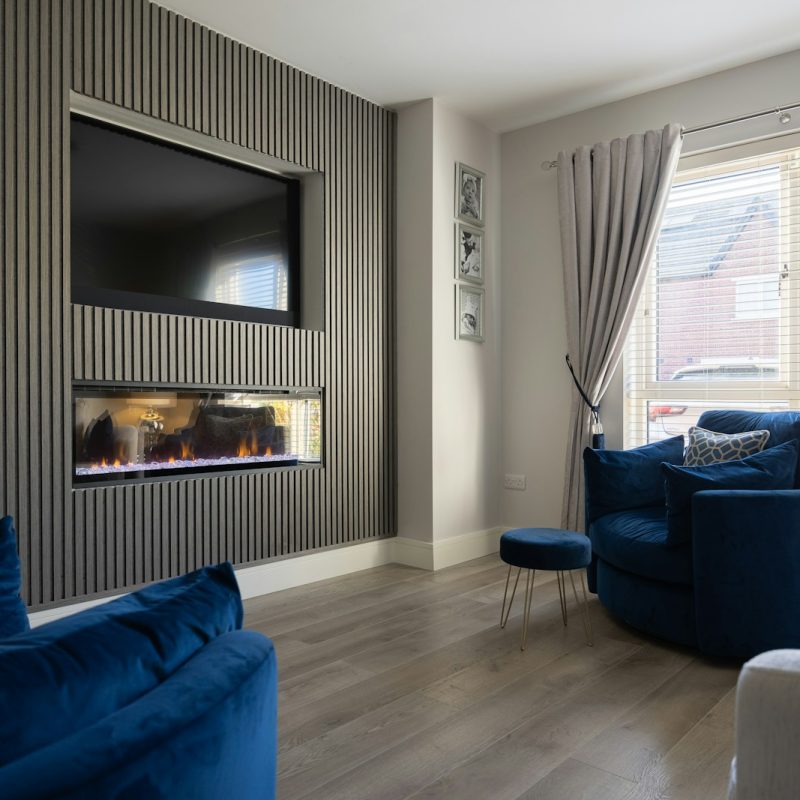 a living room filled with furniture and a flat screen tv